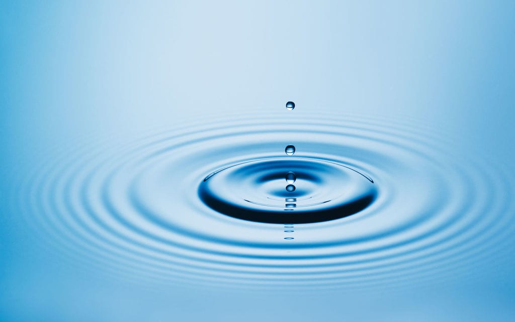 drop in a pond representing our conception and waves of influence spiritual healing