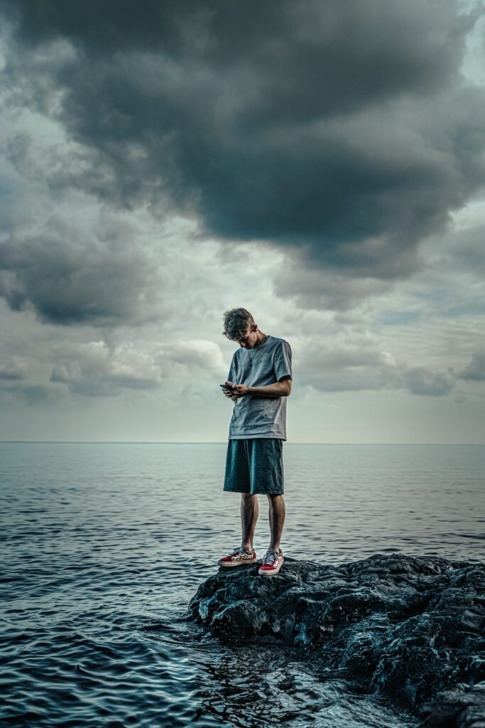 young man looking at phone embodied living