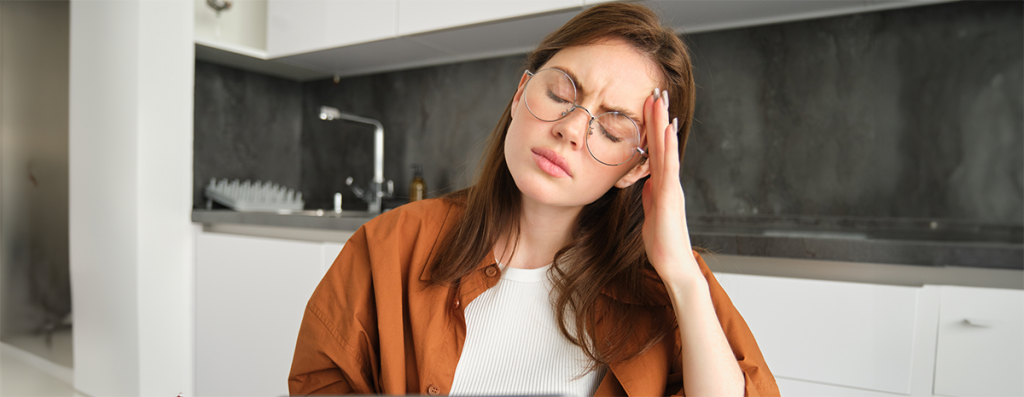 Girl experiencing a headache or migraine, The Spiritual Meaning of Headaches