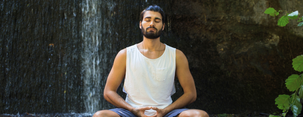 A man meditating peacefully in the forest