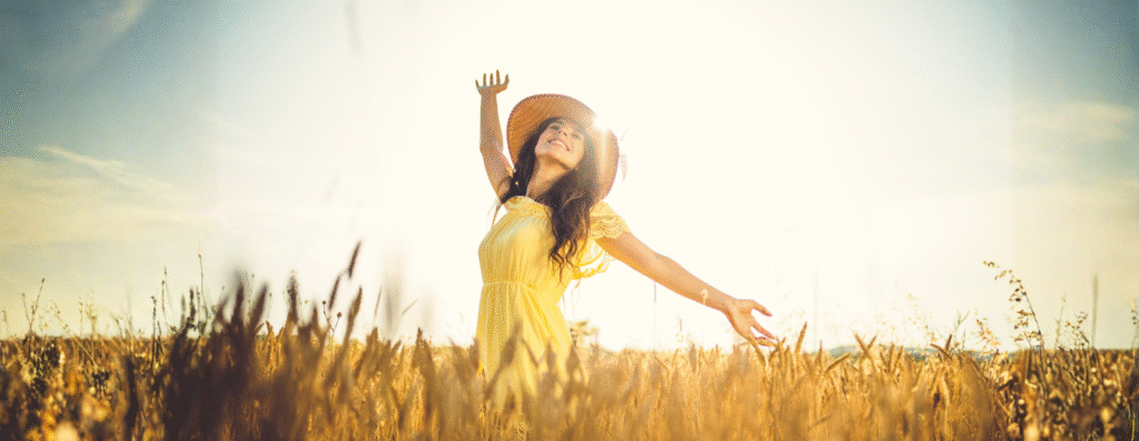 a happy woman walking in an open field